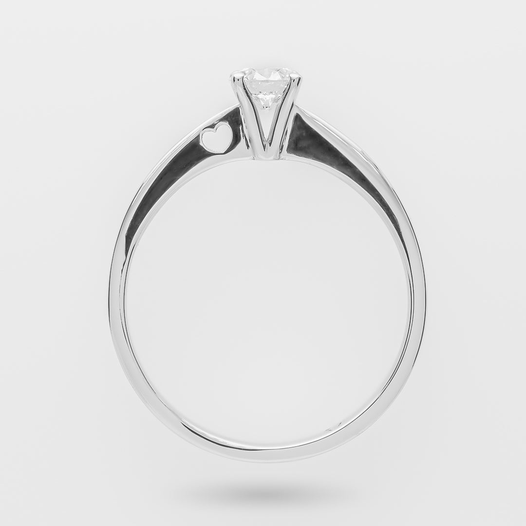 White ring with a diamond and a heart on the shank on a light gray background