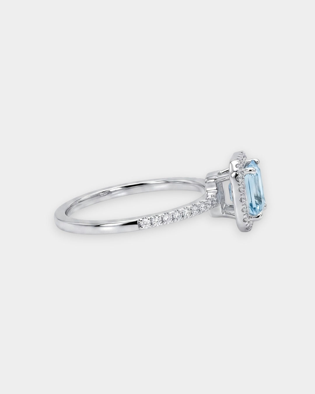 Silver ring with a blue aquamarine gemstone on a white background