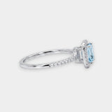 Silver ring with a blue aquamarine gemstone on a white background