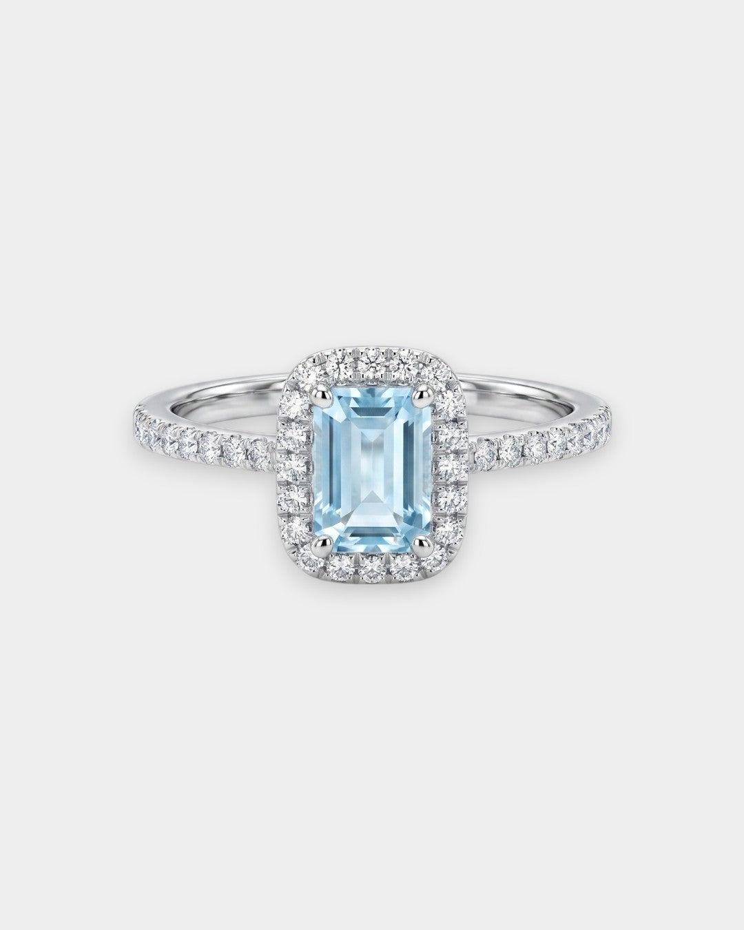 Silver ring with a blue aquamarine gemstone on a white background