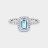 Silver ring with a blue aquamarine gemstone on a white background