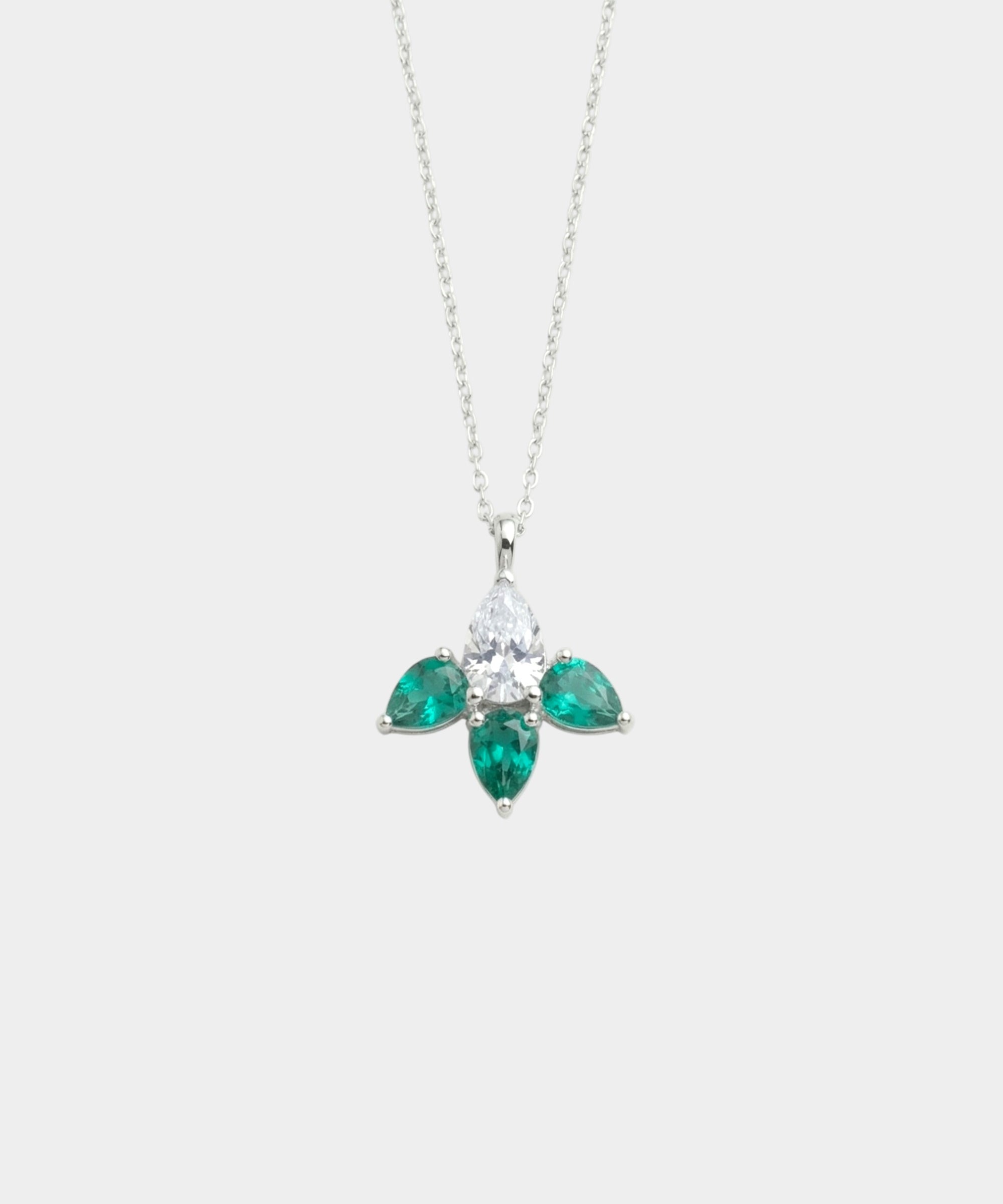 Diamond and emerald necklace on a white background