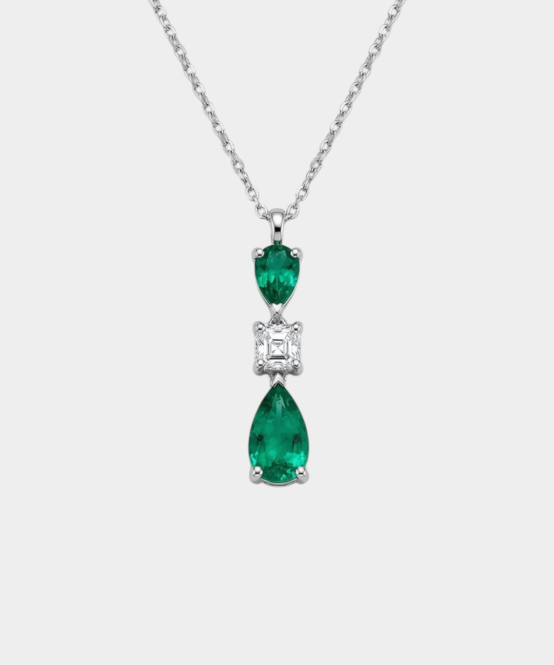 Diamond and emerald necklace on a white background