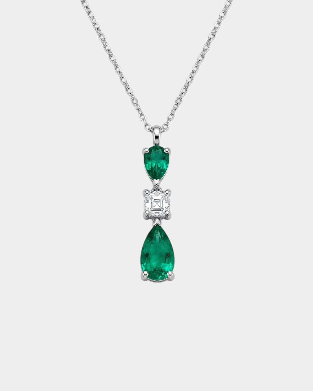 Diamond and emerald necklace on a white background