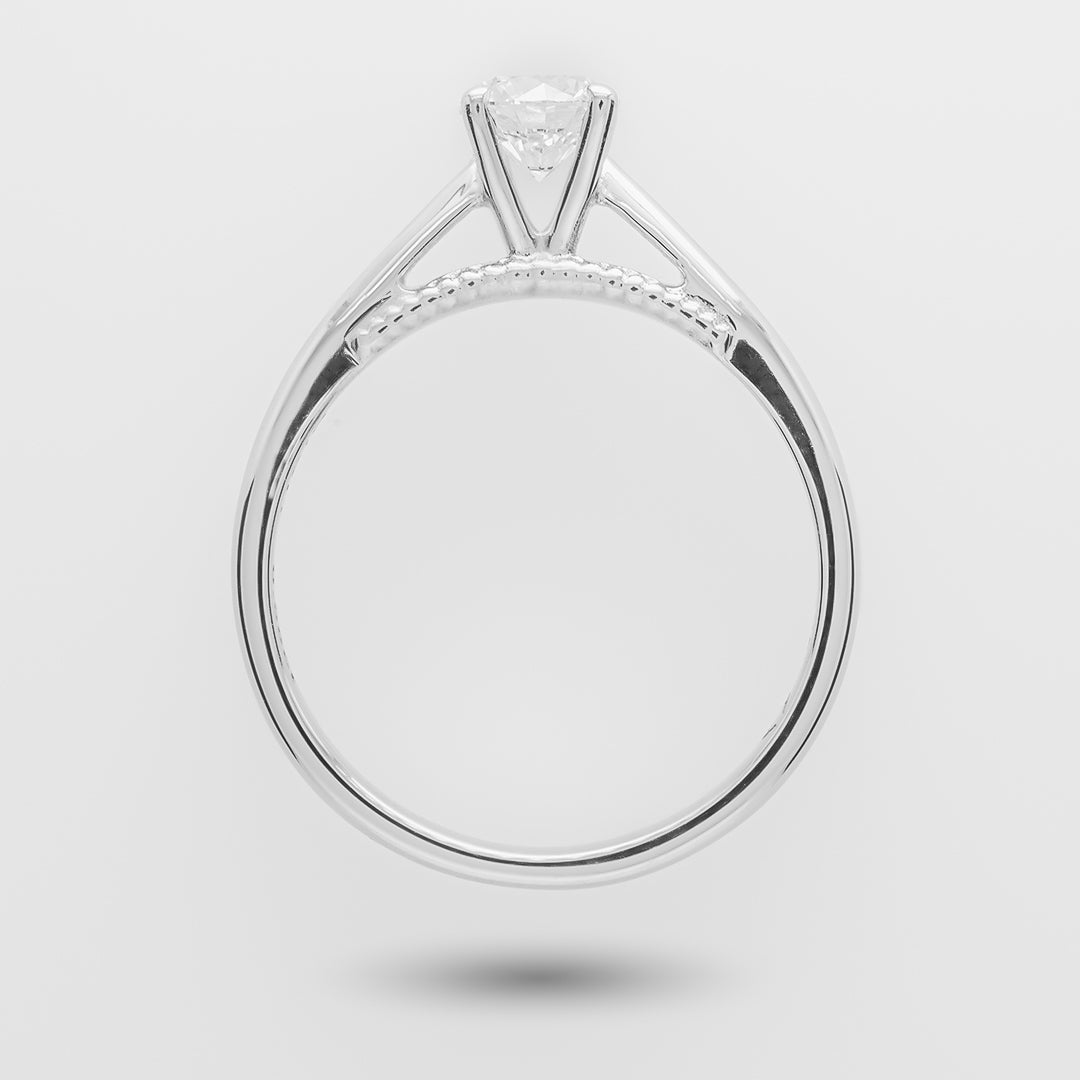 White gold enegagement ring with a diamond on a light gray background