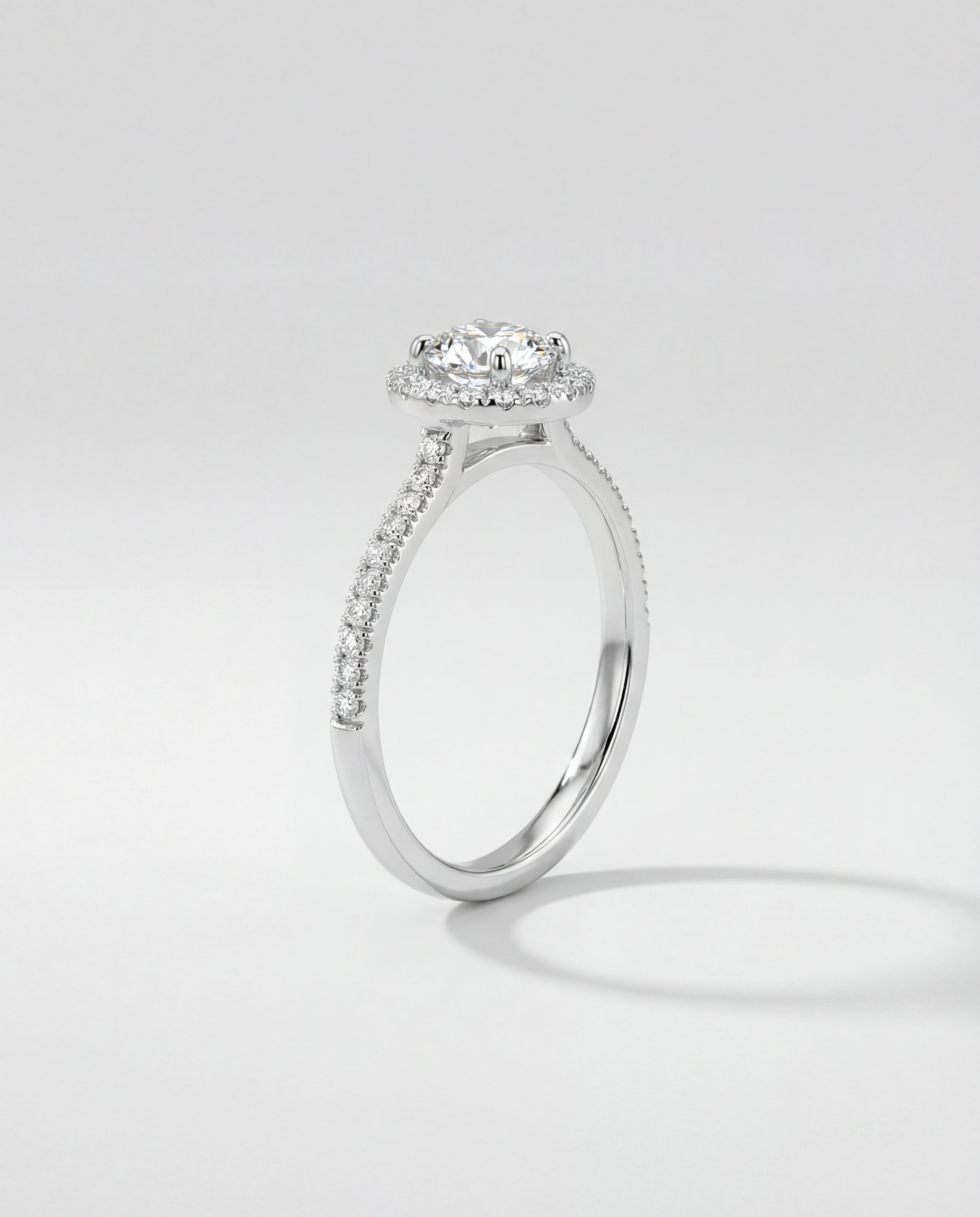 Engagement ring with a diamond on a light gray background