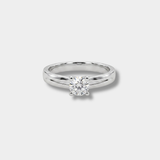 A classic solitaire engagement ring featuring a round brilliant-cut diamond set in a polished silver-colored band, shown against a neutral light gray background.