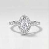 Diamond ring with a marquise-shaped center stone on a light gray background