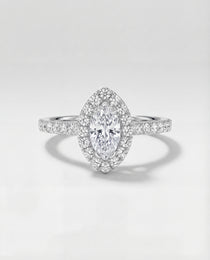 Diamond ring with a marquise-shaped center stone on a light gray background