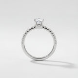 Silver ring with a diamond on a light gray background