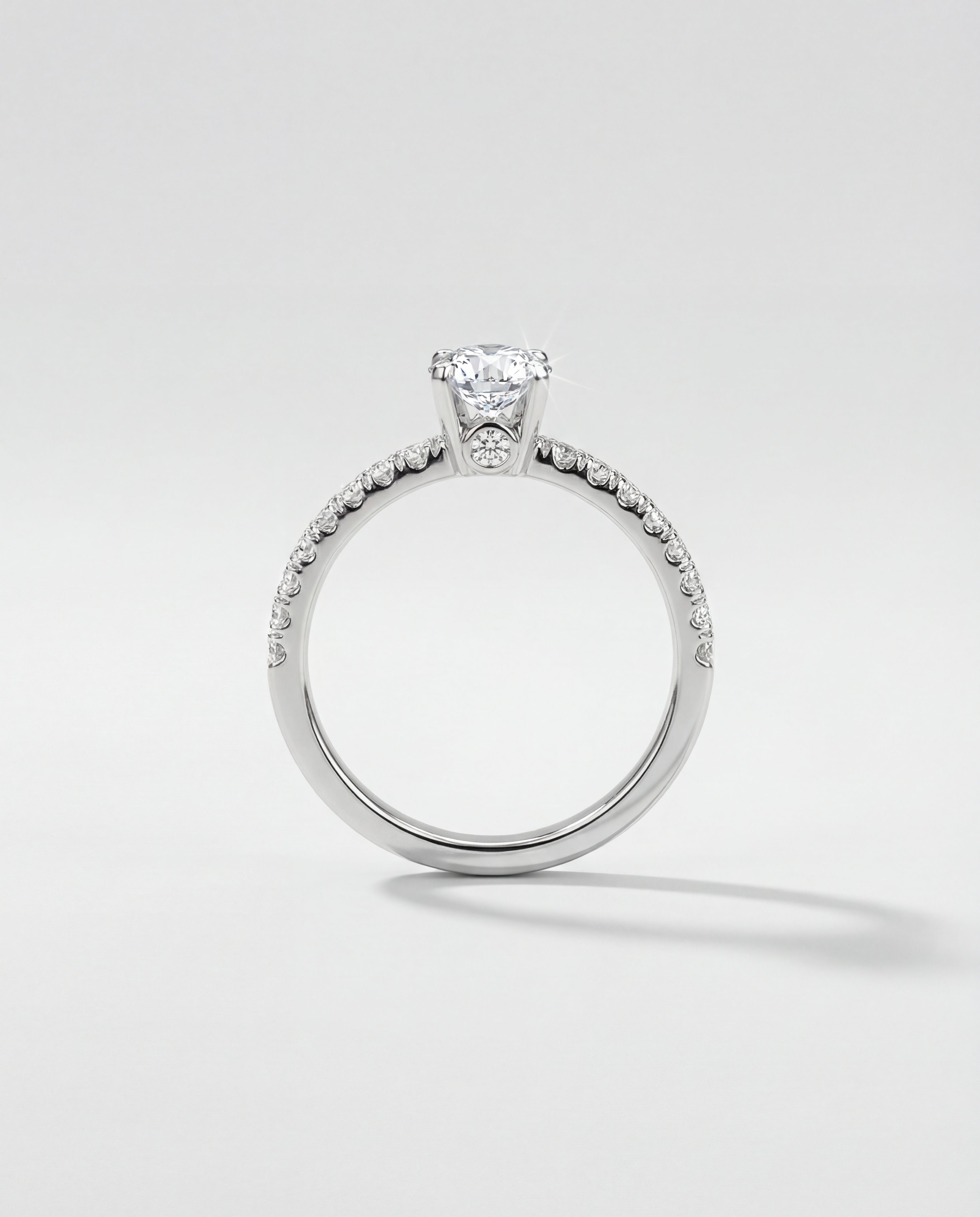 Silver ring with a diamond on a light gray background