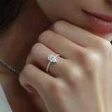 Close-up of a hand wearing a diamond ring with a blurred background