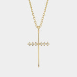 Gold cross necklace with diamonds on a white background