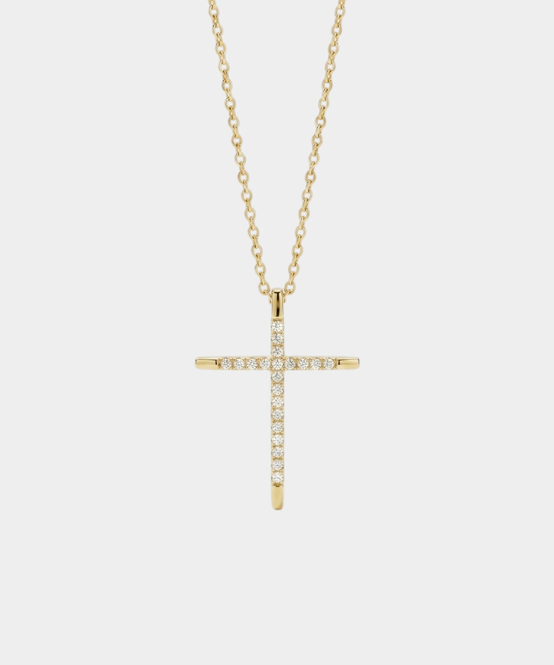 Gold cross necklace with diamonds on a white background