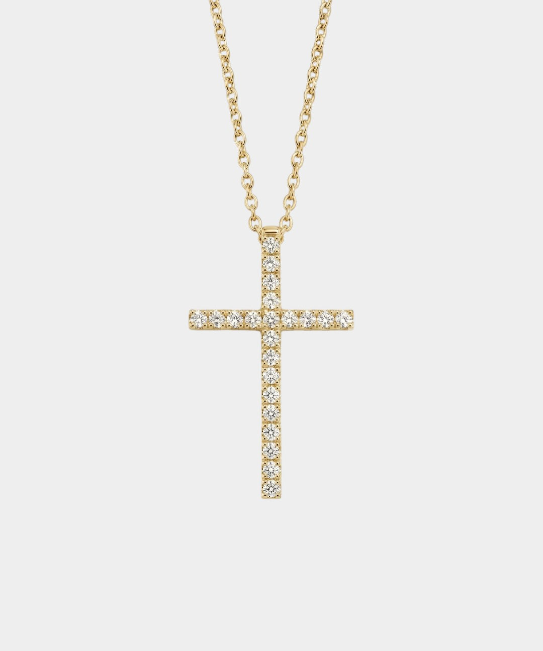 Gold cross necklace with diamonds on a white background