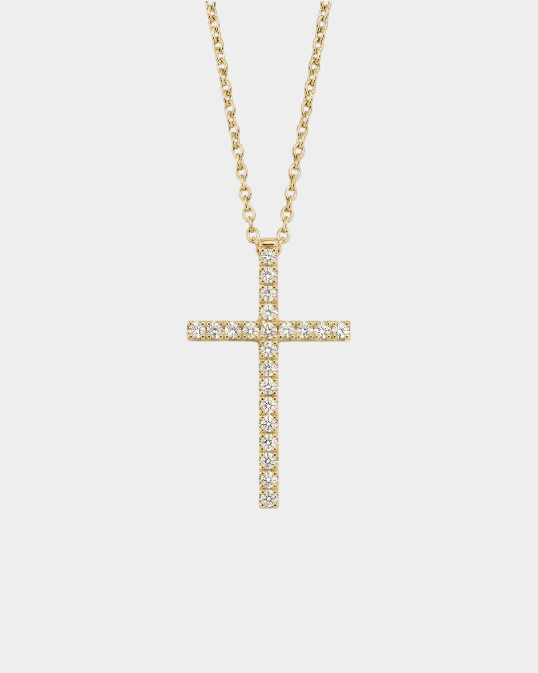 Gold cross necklace with diamonds on a white background