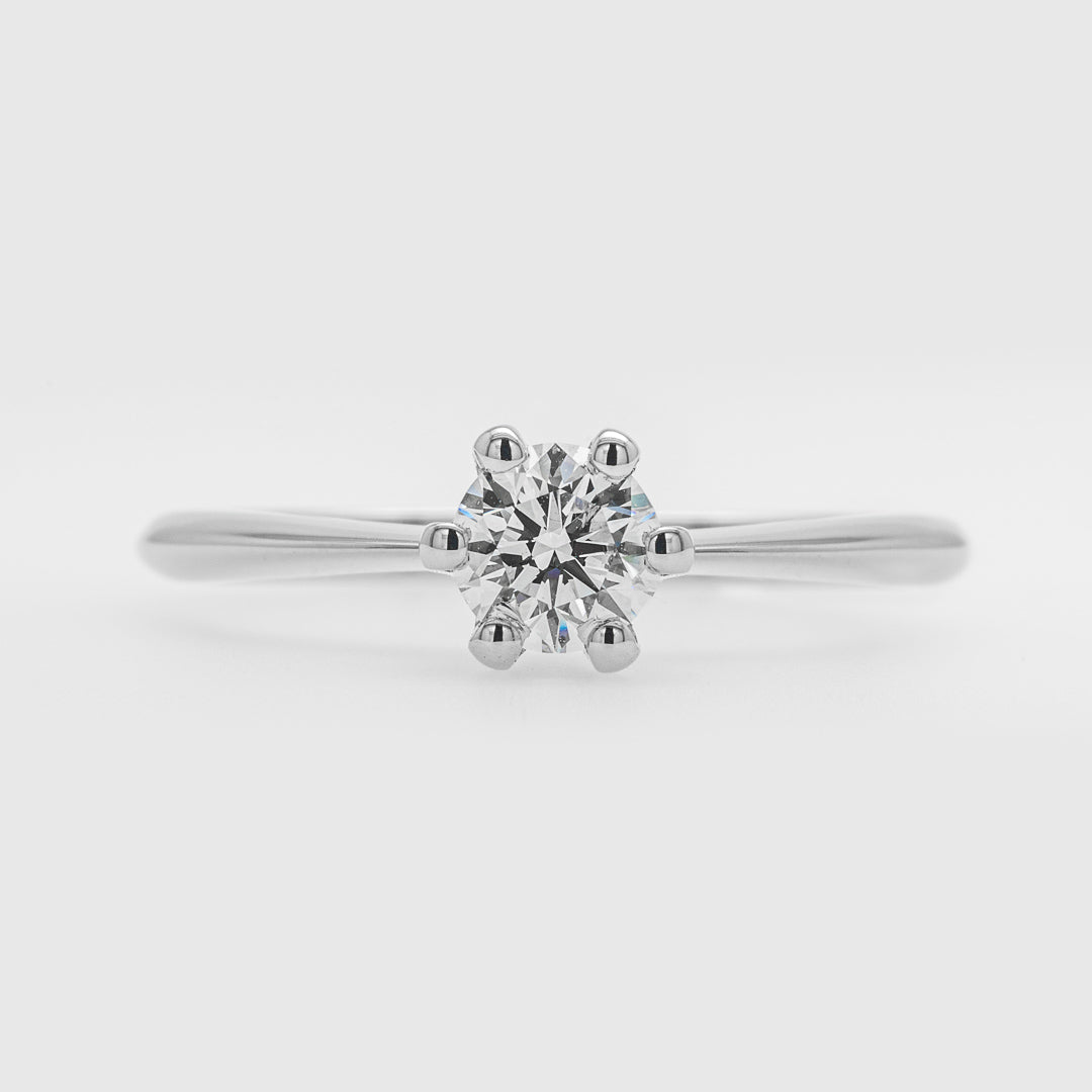 Diamond ring on a light gray background