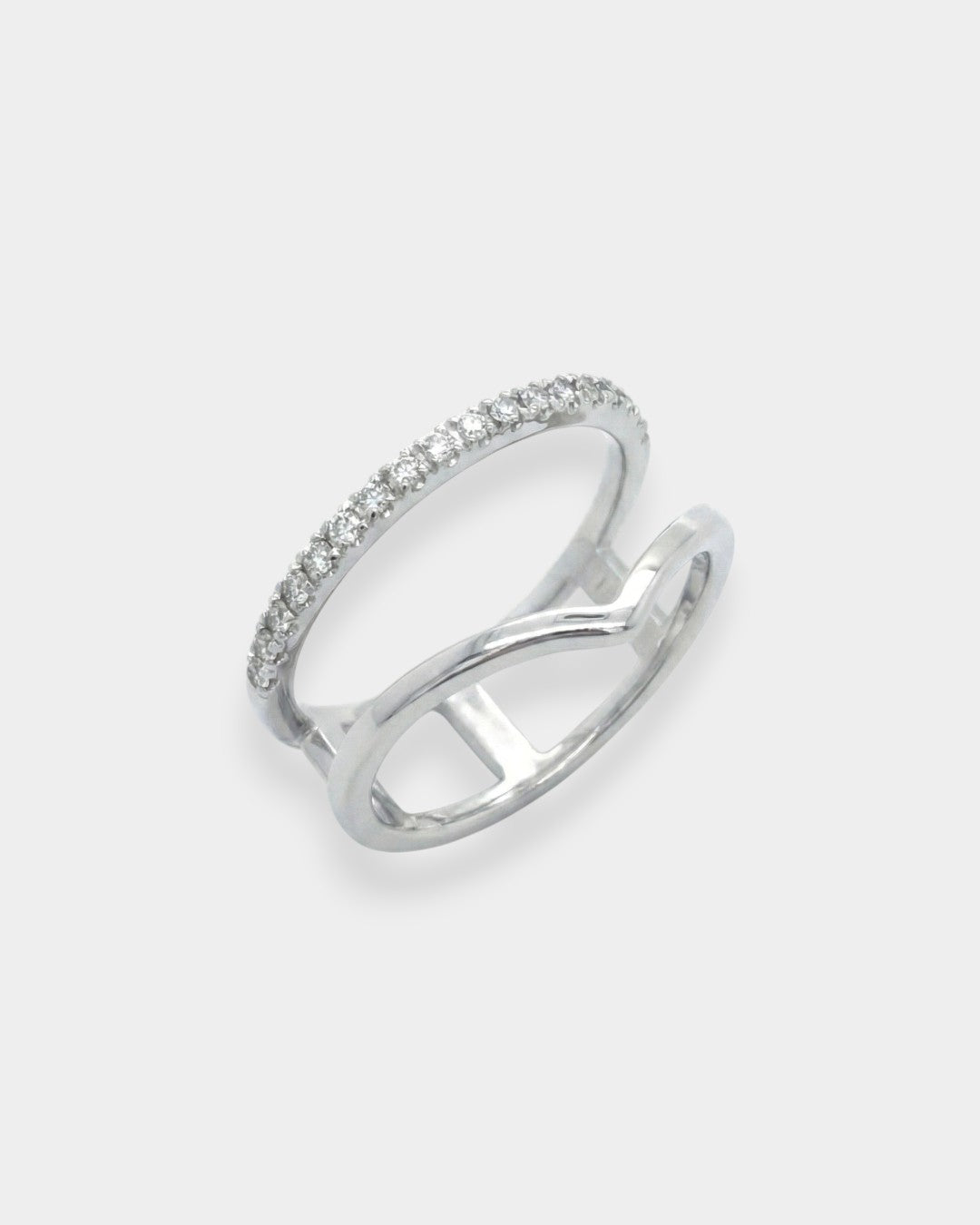 White gold ring with diamonds on a light gray background