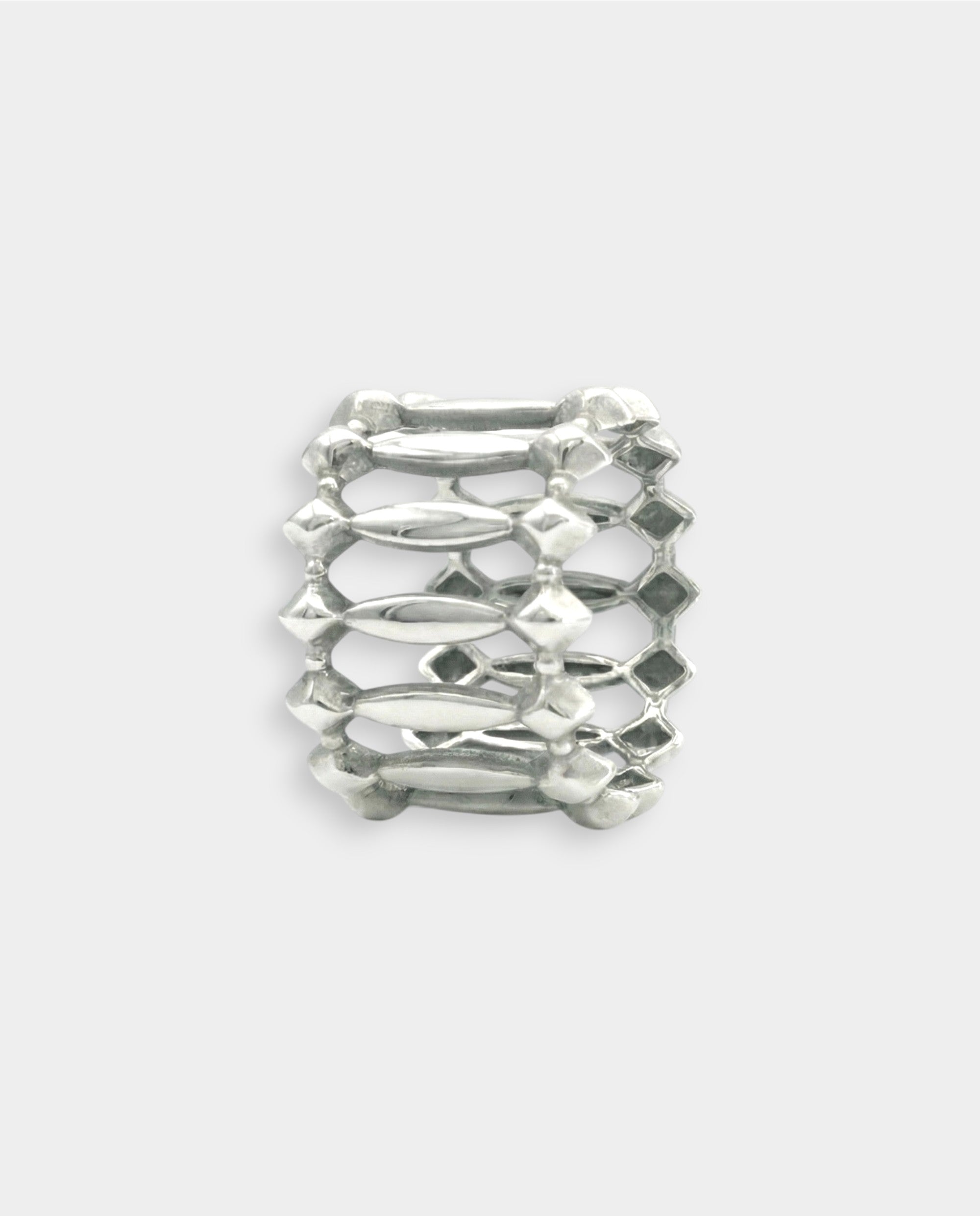 White gold metallic ring with textured design on a white background