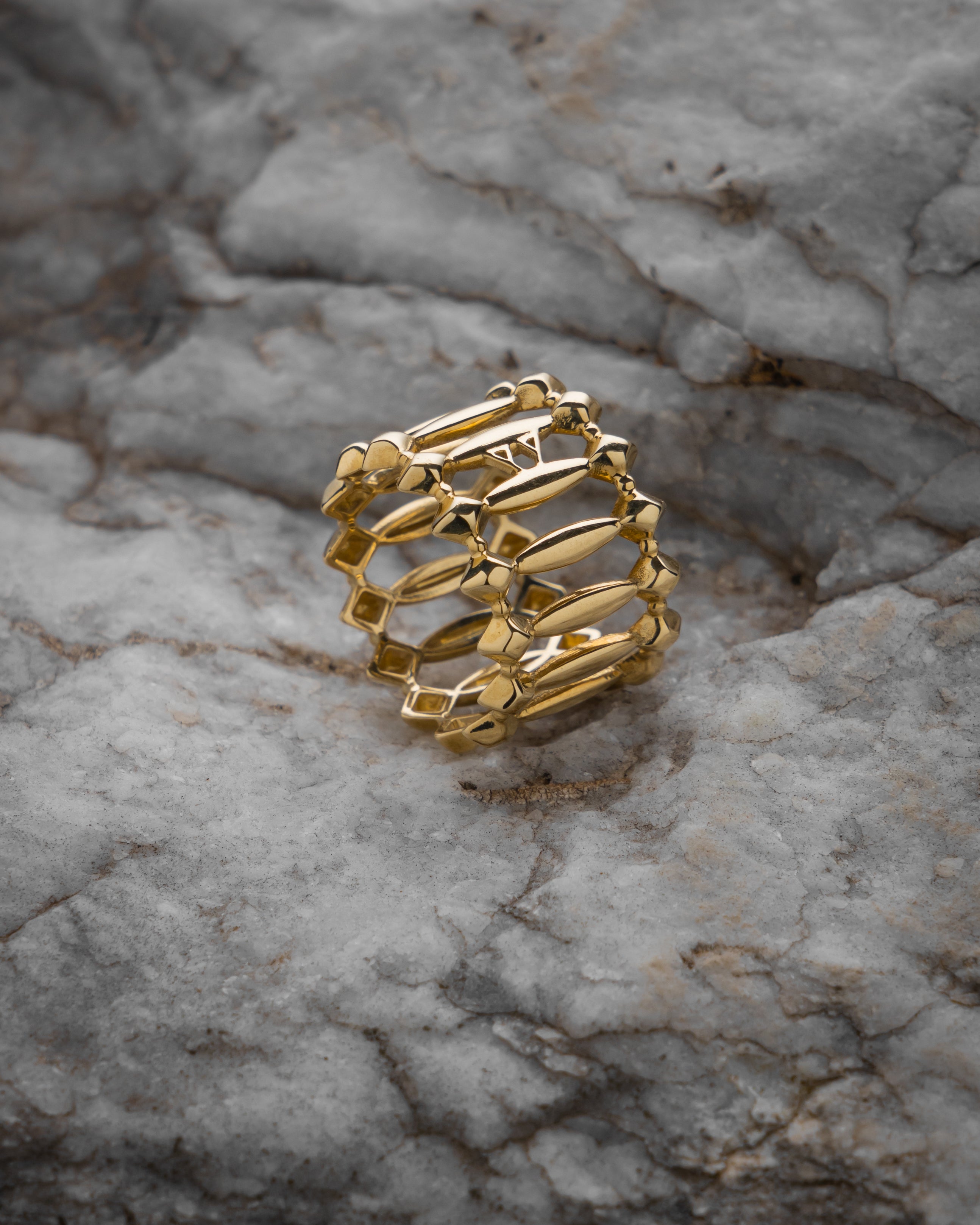 Gold ring on a textured stone surface