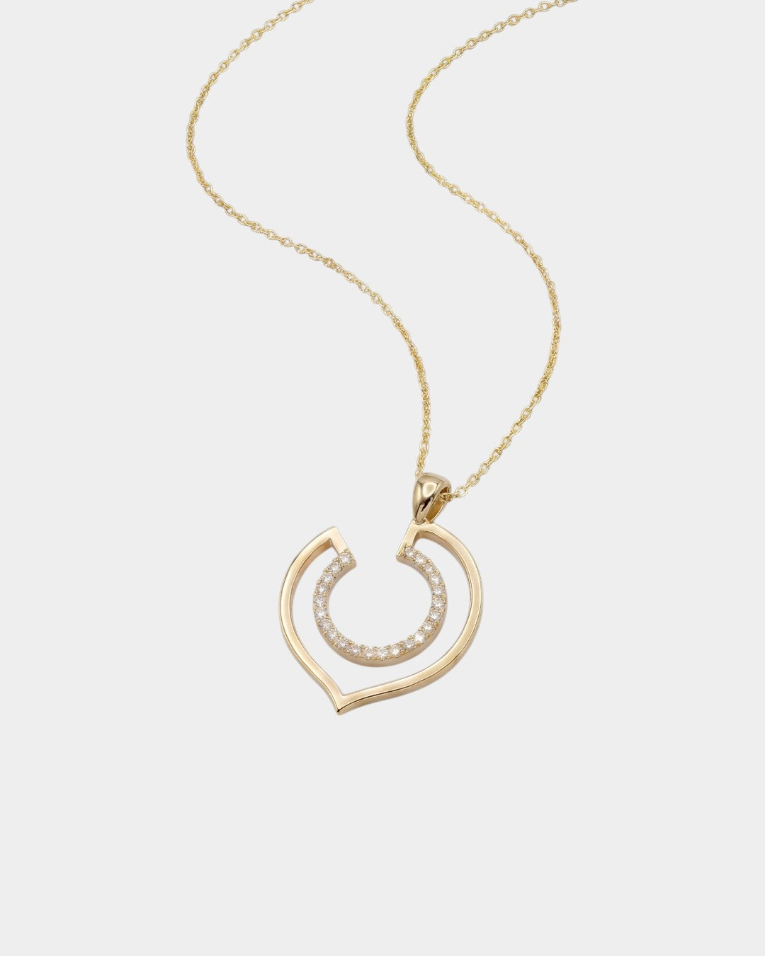 Yellow gold necklace with a geometric-shaped pendant on a white background