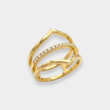 Gold ring with diamond accents on a light gray background