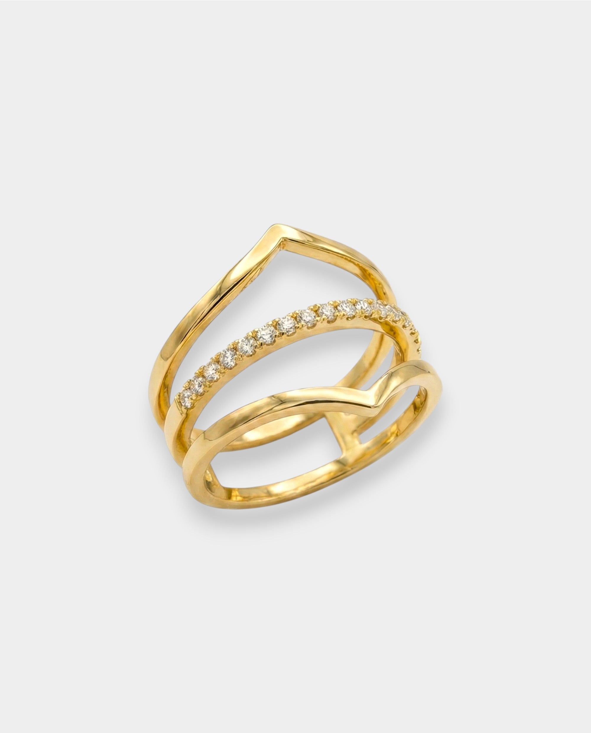 Gold ring with diamond accents on a light gray background