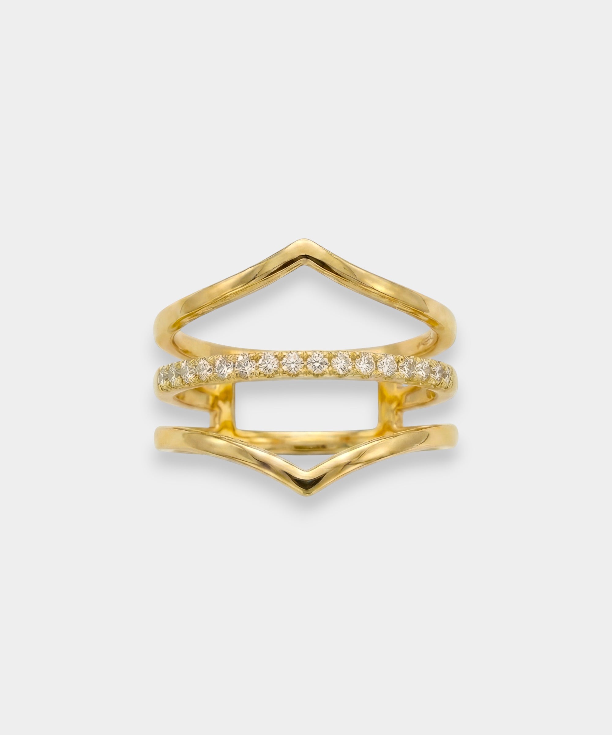 Gold ring with diamond accents on a light gray background
