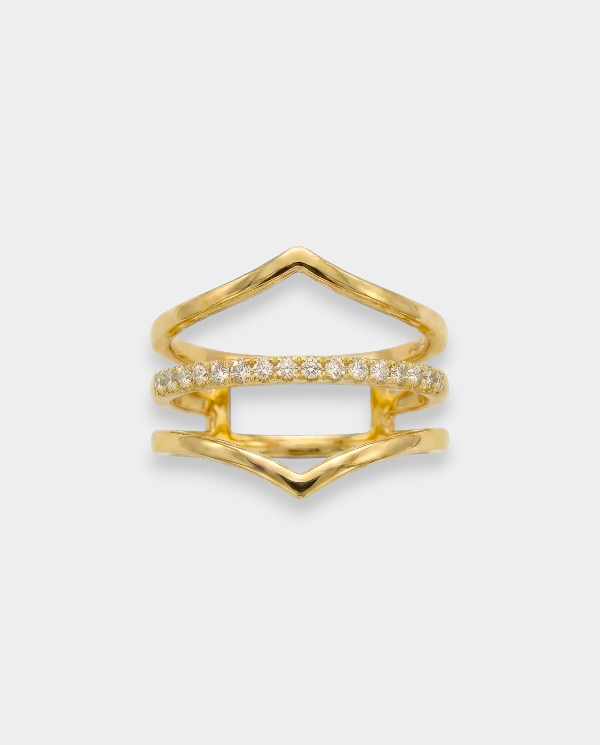 Gold ring with diamond accents on a light gray background
