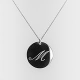Necklace with a round pendant featuring the letter 'M' on a white background