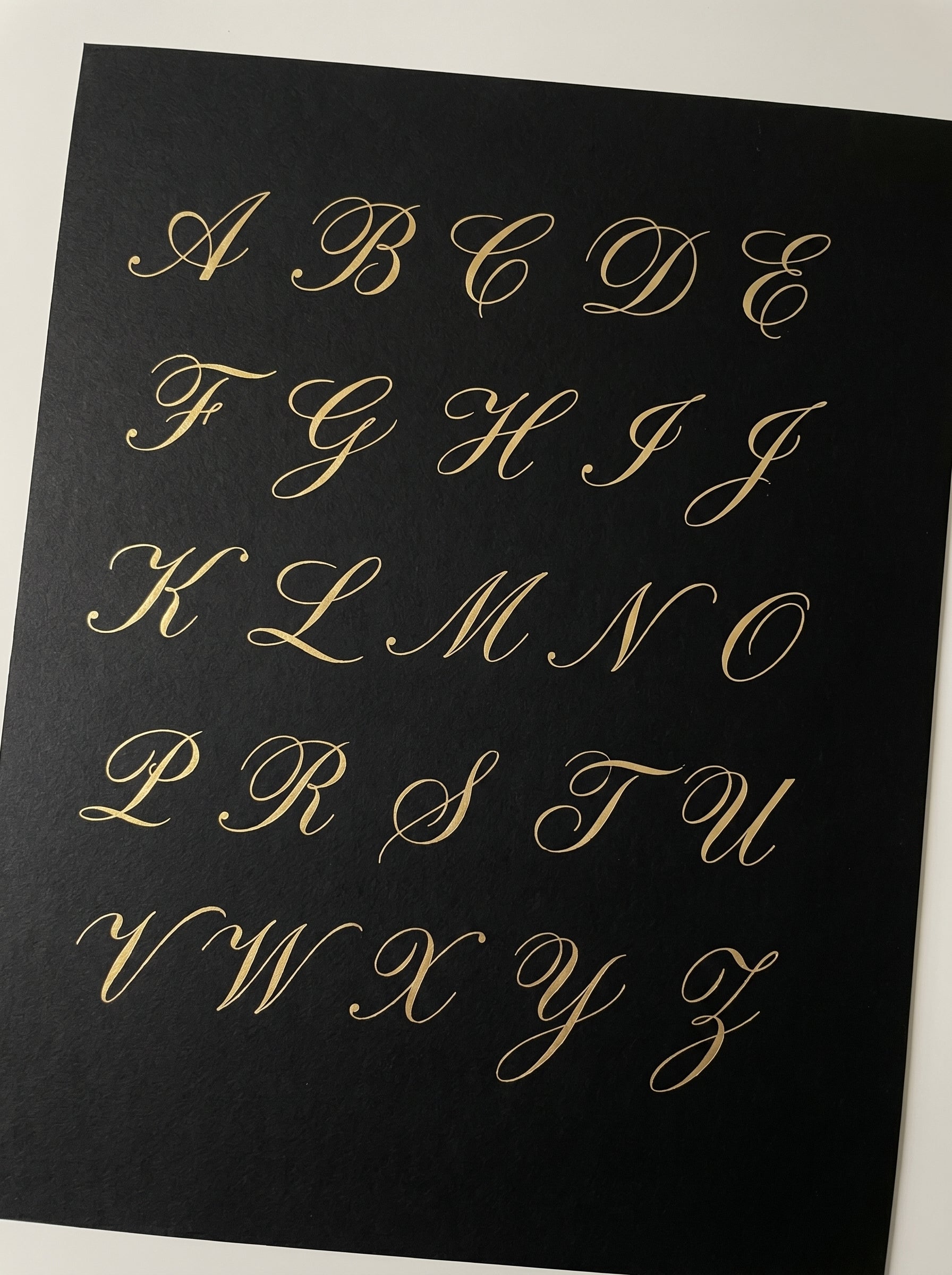 Calligraphy alphabet on a black background