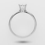 White gold ring with a diamond on a light gray background
