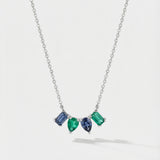 Necklace with four mixed-shaped gemstones on a light gray background