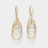 Gold oval hoop earrings on a light gray background