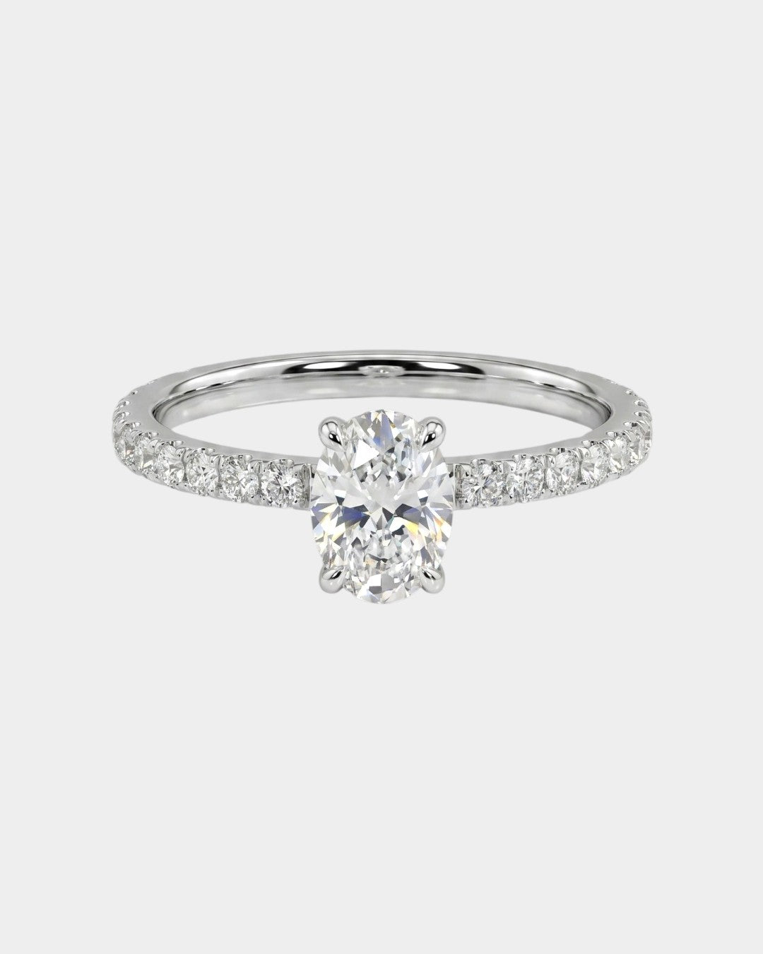 Oval-cut engagement ring with pave diamonds. 