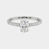 Oval-cut engagement ring with pave diamonds. 