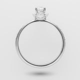 white gold ring with a diamond on a light gray background