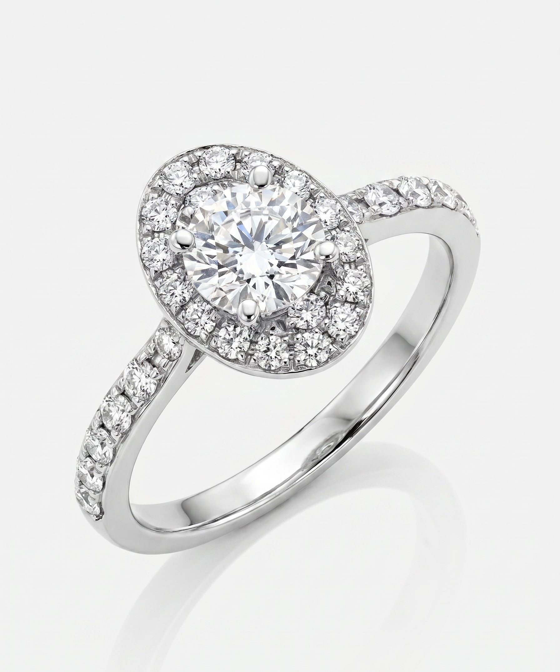 Diamond ring with a halo setting on a white background