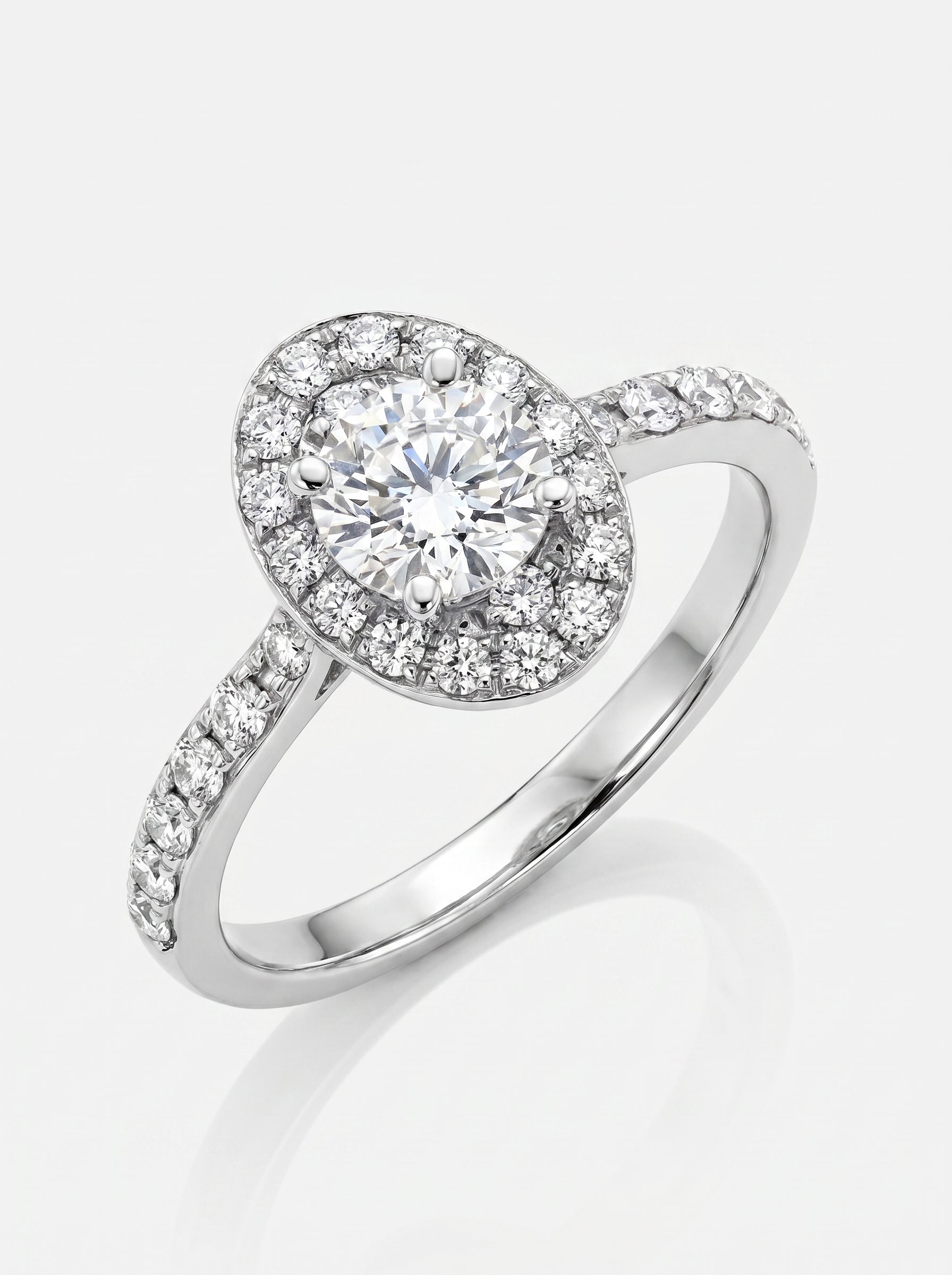 Diamond ring with a halo setting on a white background