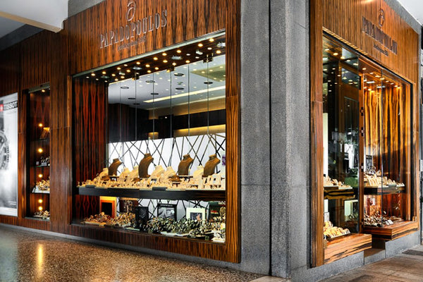 Luxury jewelry store with wooden facade and glass display windows.