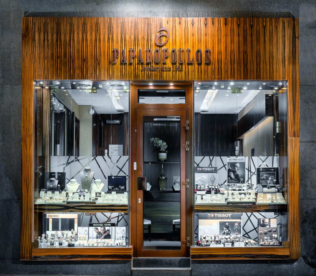 Paracoulos jewelry store front with wooden facade and glass display cases.