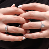 a hand wearing multiple engagement rings