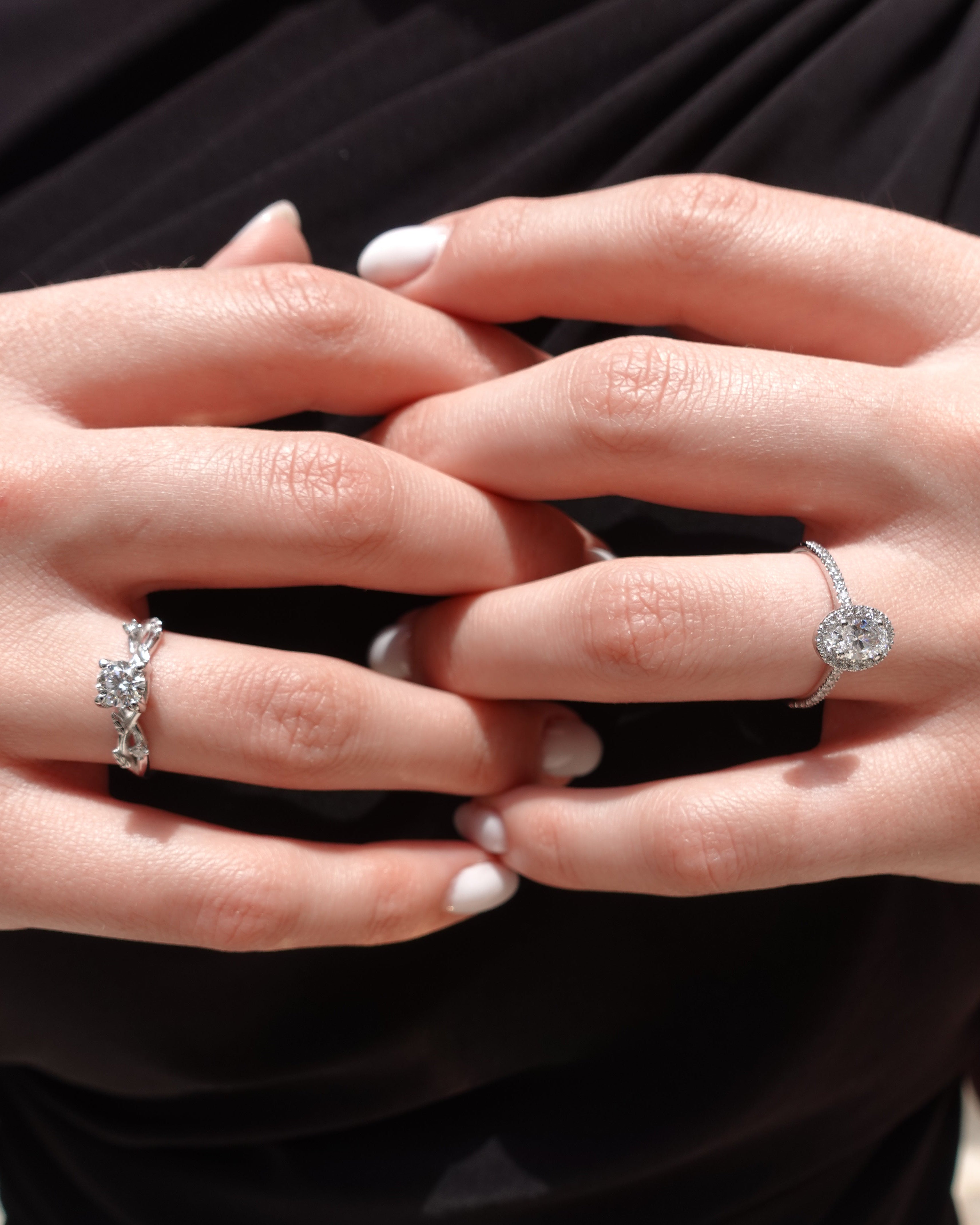 a hand wearing multiple engagement rings