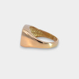 Gold ring with textured surface on a light gray background