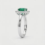 White gold ring with a green gemstone on a white background