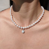 Pearl necklaces on a person's neck
