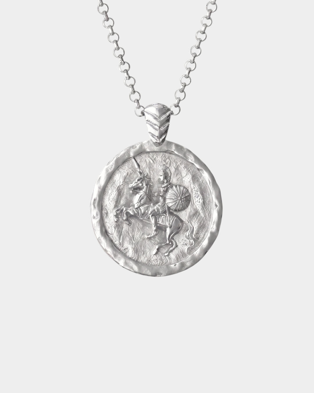 A silver medallion pendant necklace on a delicate silver chain, shown against a light gray background.