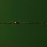 Gold chain on a green background