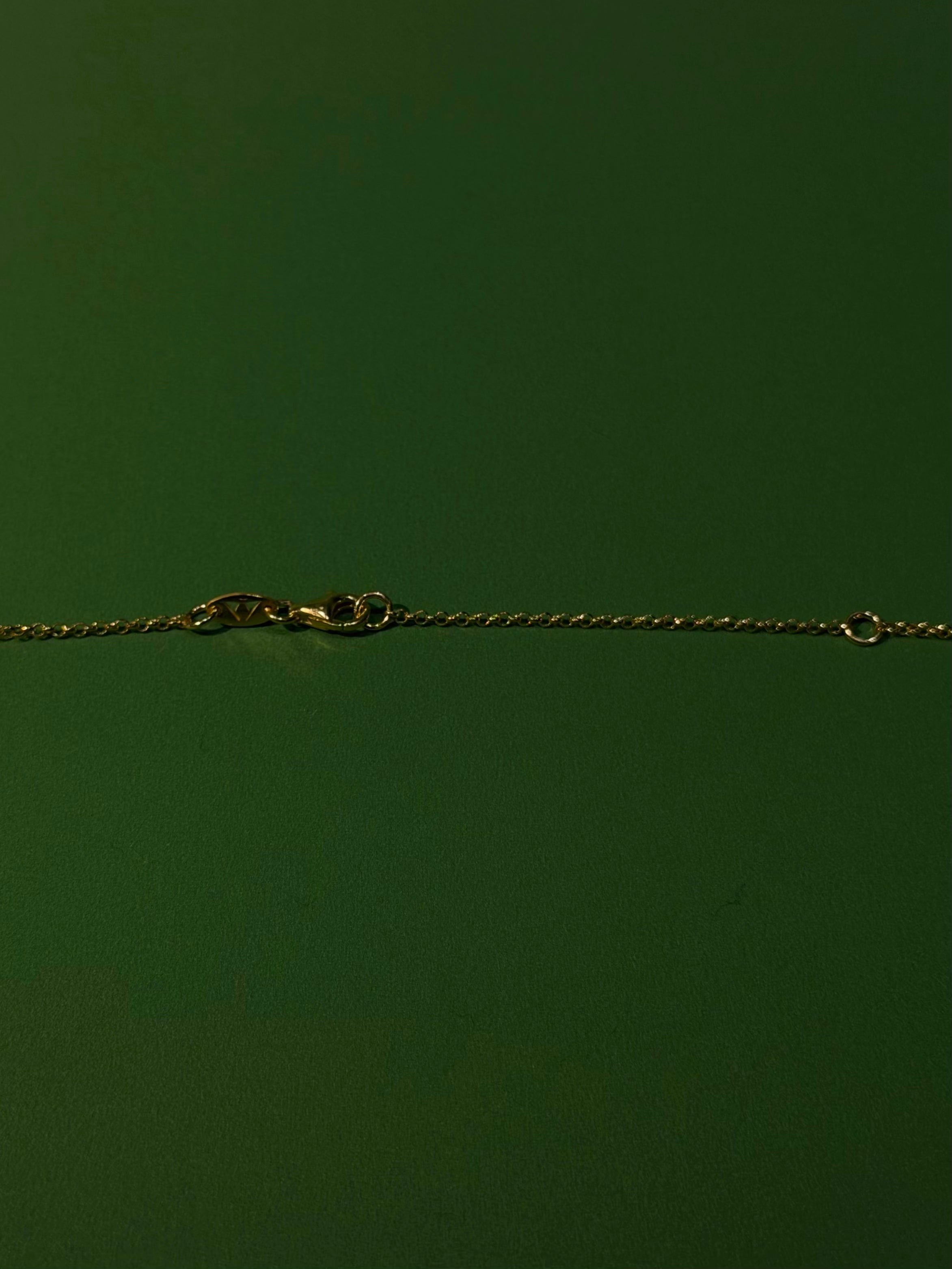 Gold chain on a green background