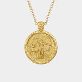 Gold necklace with a circular pendant featuring an artemis figure and deer on a white background